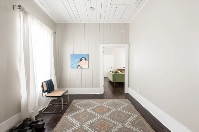 a view of a hallway with workspace and a window