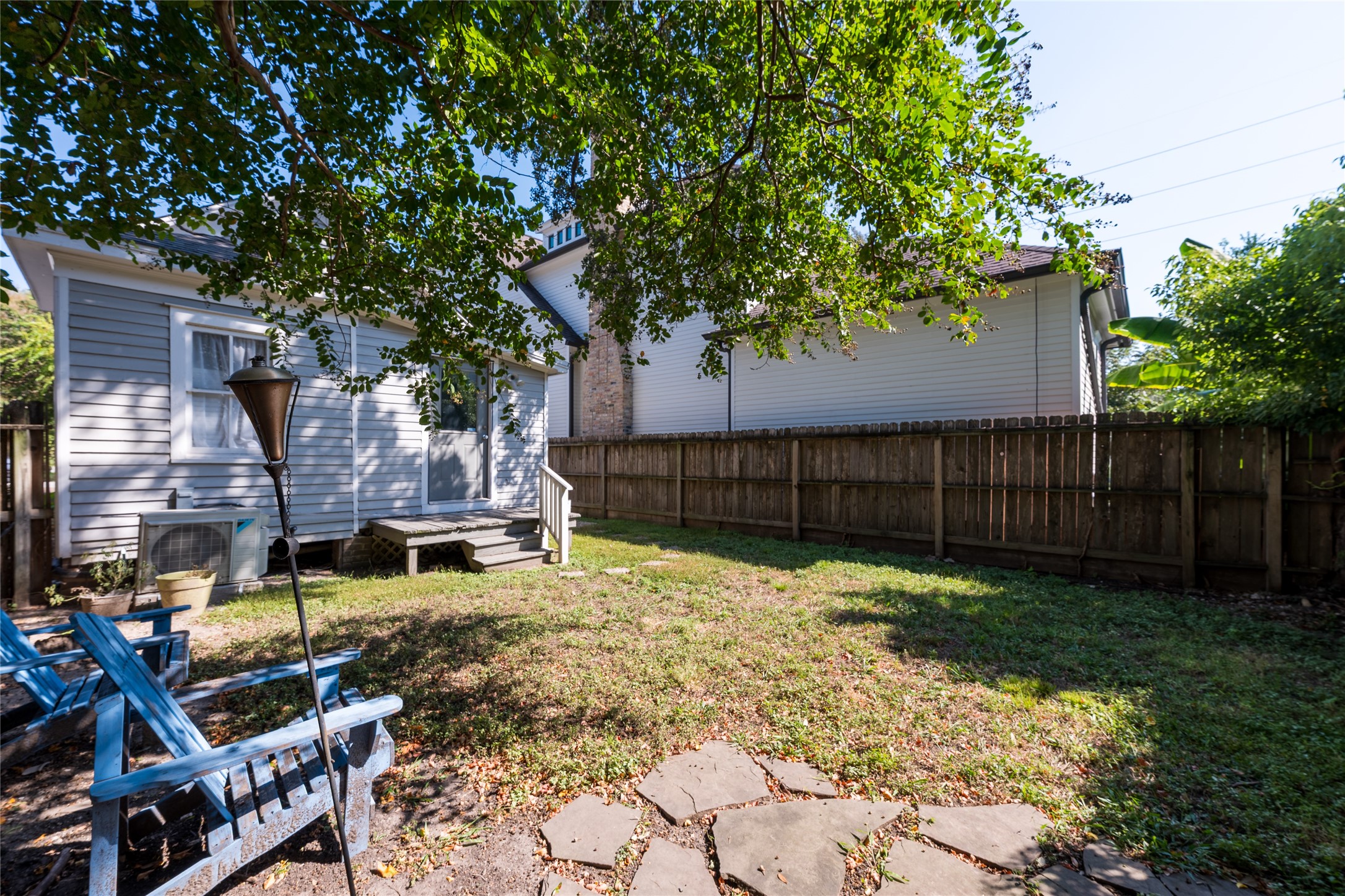 2011 Decatur Street Houston, TX 77007 - Photo 34 of 35 a backyard of a house with wooden fence and a large tree