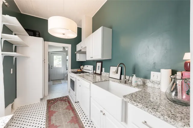 a kitchen with a sink and a stove top oven