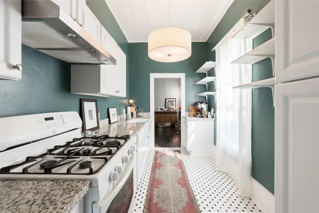 a kitchen with stainless steel appliances granite countertop a stove and a refrigerator
