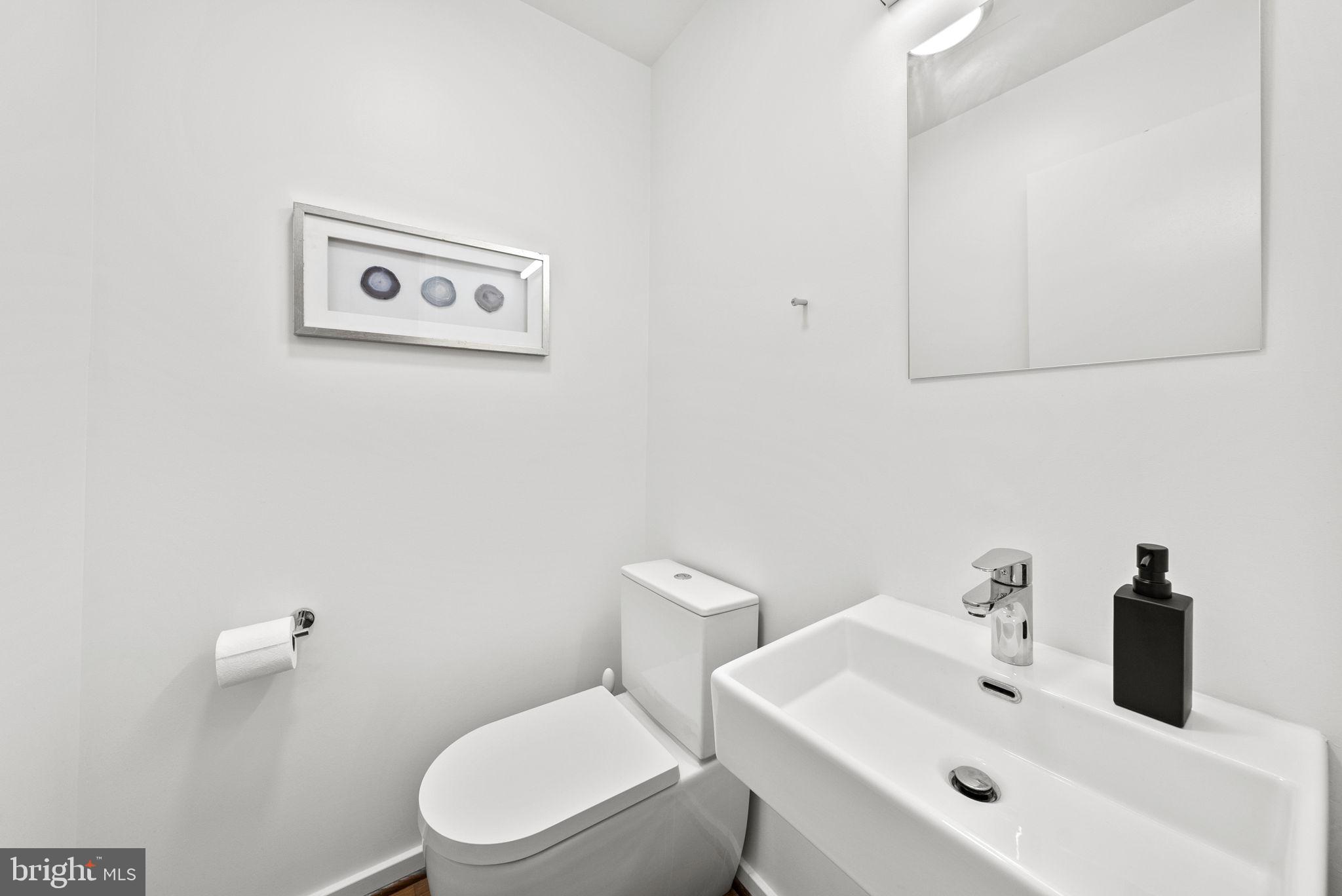 11585 Maple Ridge Road Reston, VA 20190 - Photo 11 of 48 a white toilet sitting next to a bathroom sink