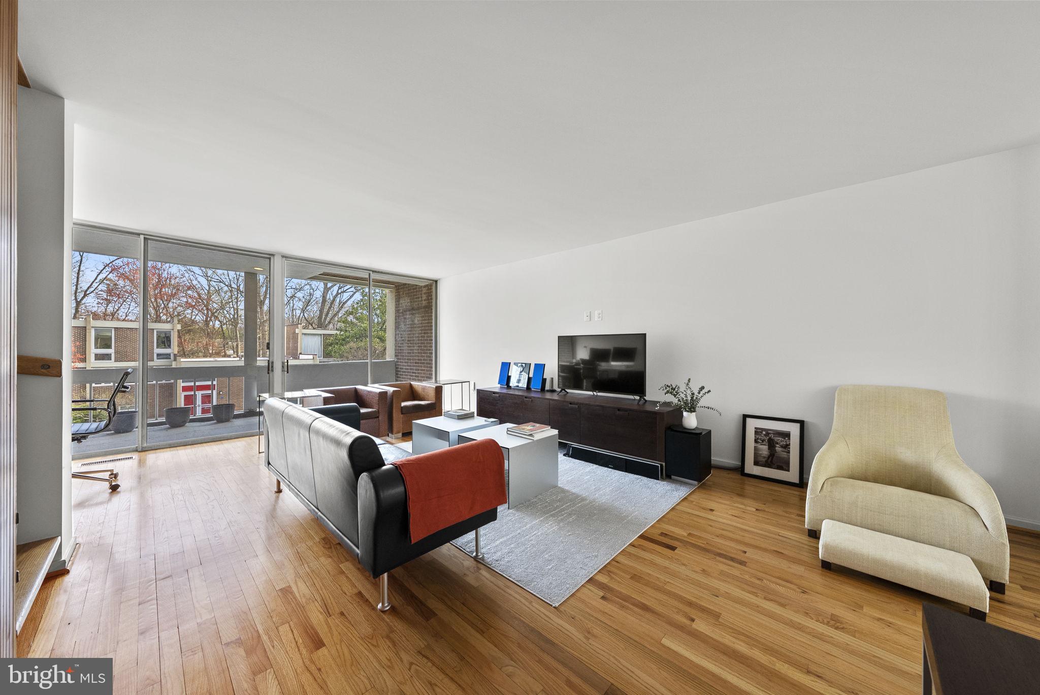11585 Maple Ridge Road Reston, VA 20190 - Photo 12 of 48 a living room with furniture and a flat screen tv