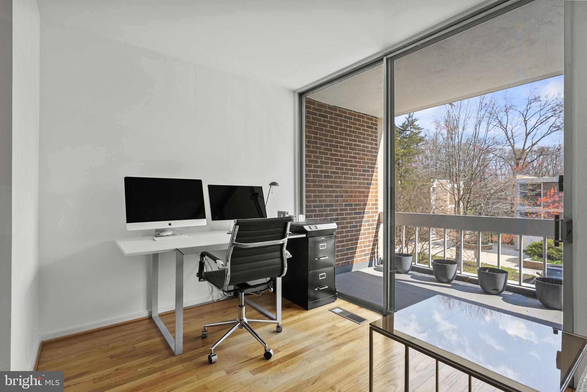 11585 Maple Ridge Road Reston, VA 20190 - Photo 14 of 48 a view of a workspace with furniture and a window