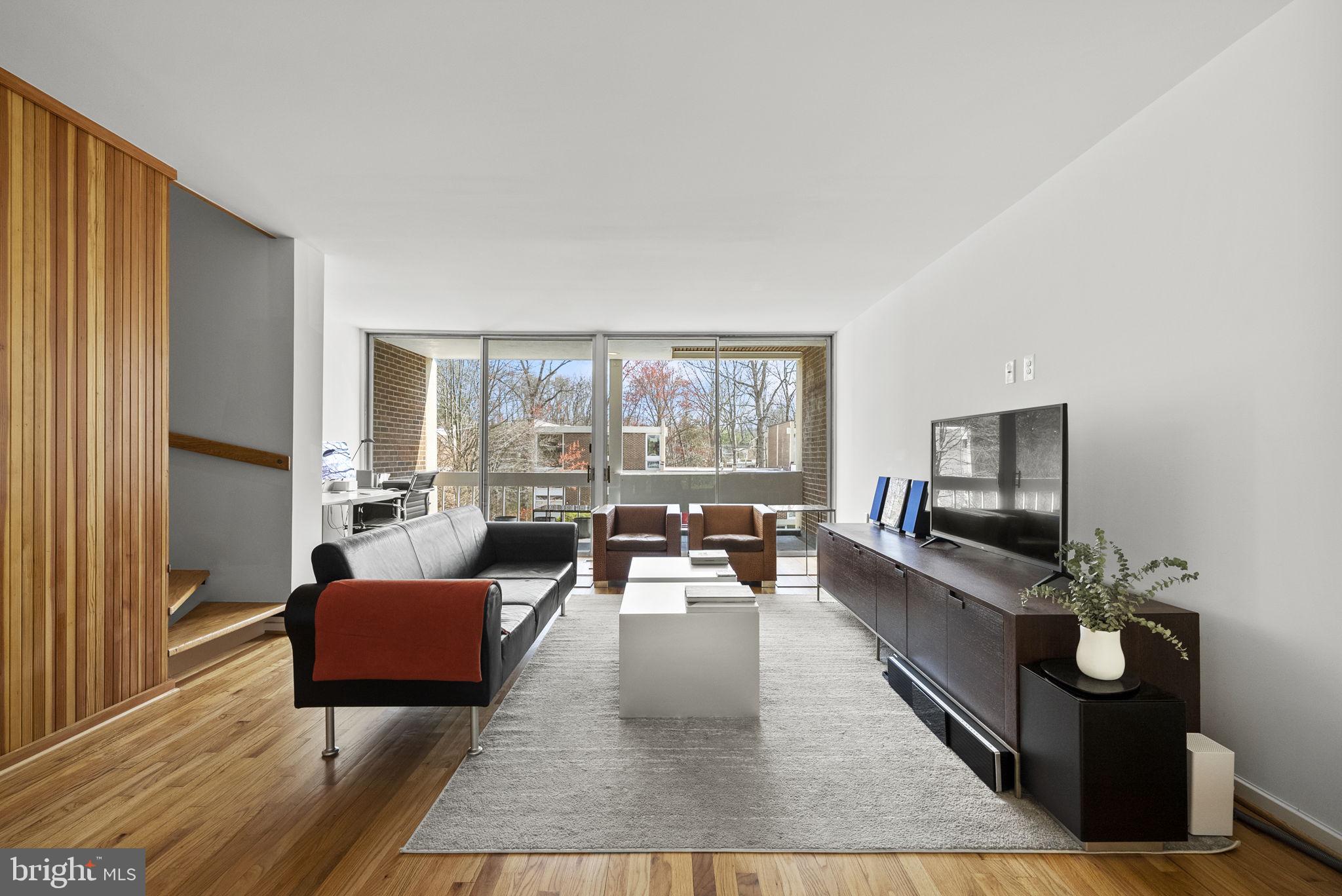 11585 Maple Ridge Road Reston, VA 20190 - Photo 15 of 48 a living room with furniture wooden floor and a fireplace