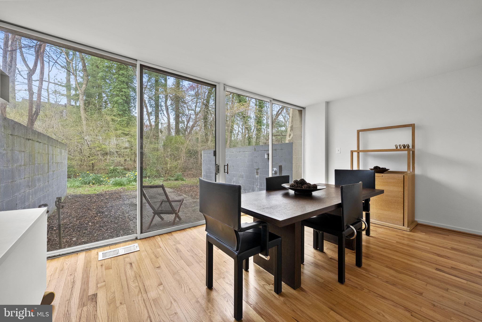 11585 Maple Ridge Road Reston, VA 20190 - Photo 17 of 48 a view of a dining room with furniture window and wooden floor