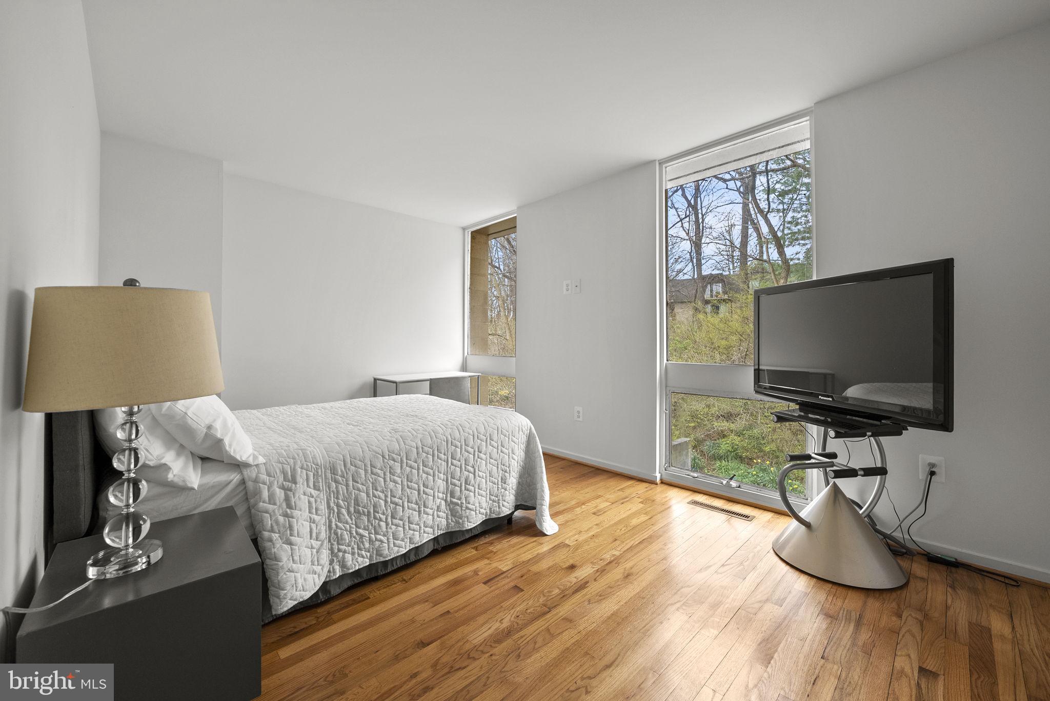 11585 Maple Ridge Road Reston, VA 20190 - Photo 22 of 48 a bedroom with bed and a flat screen tv