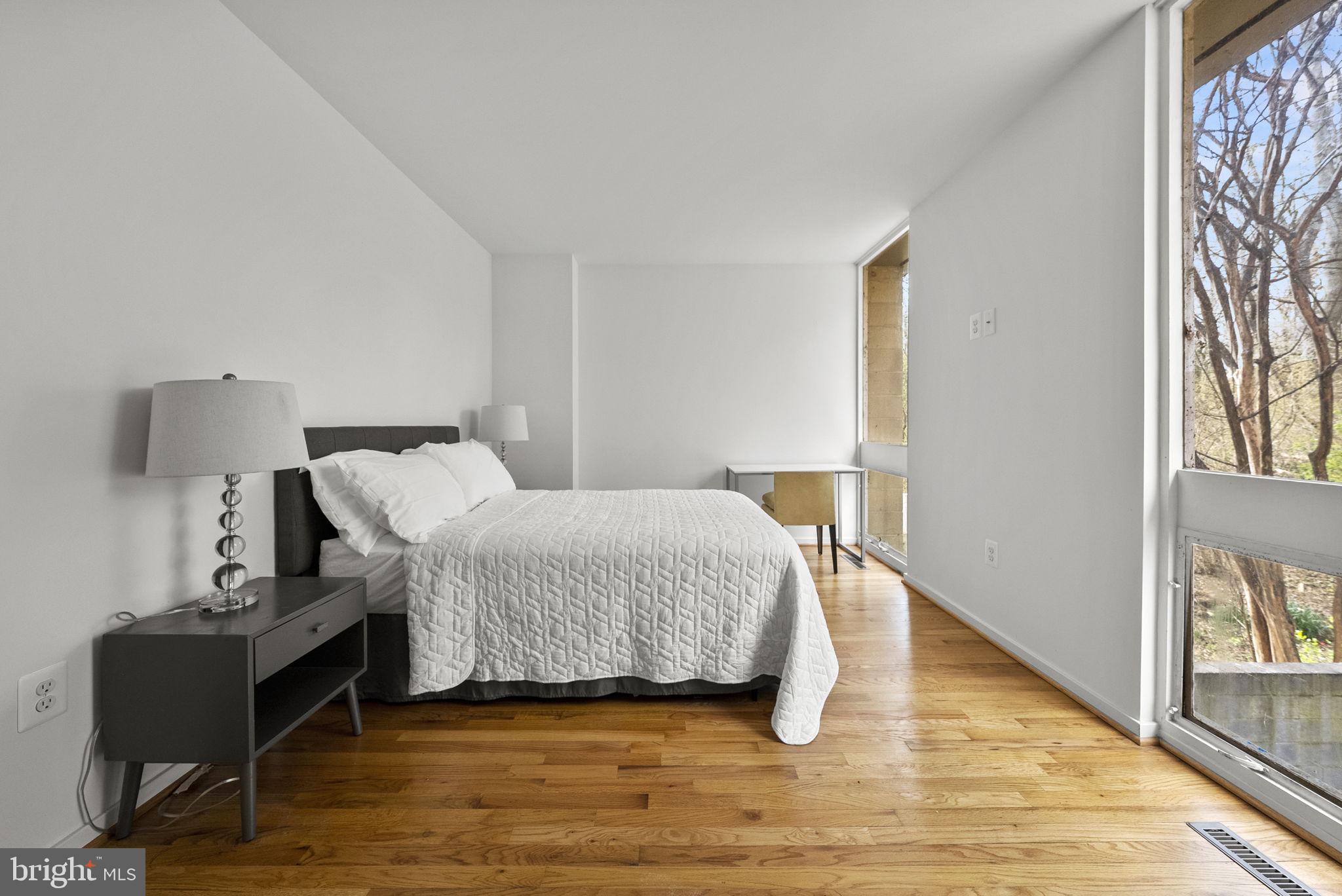 11585 Maple Ridge Road Reston, VA 20190 - Photo 23 of 48 a bedroom with a bed and wooden floor