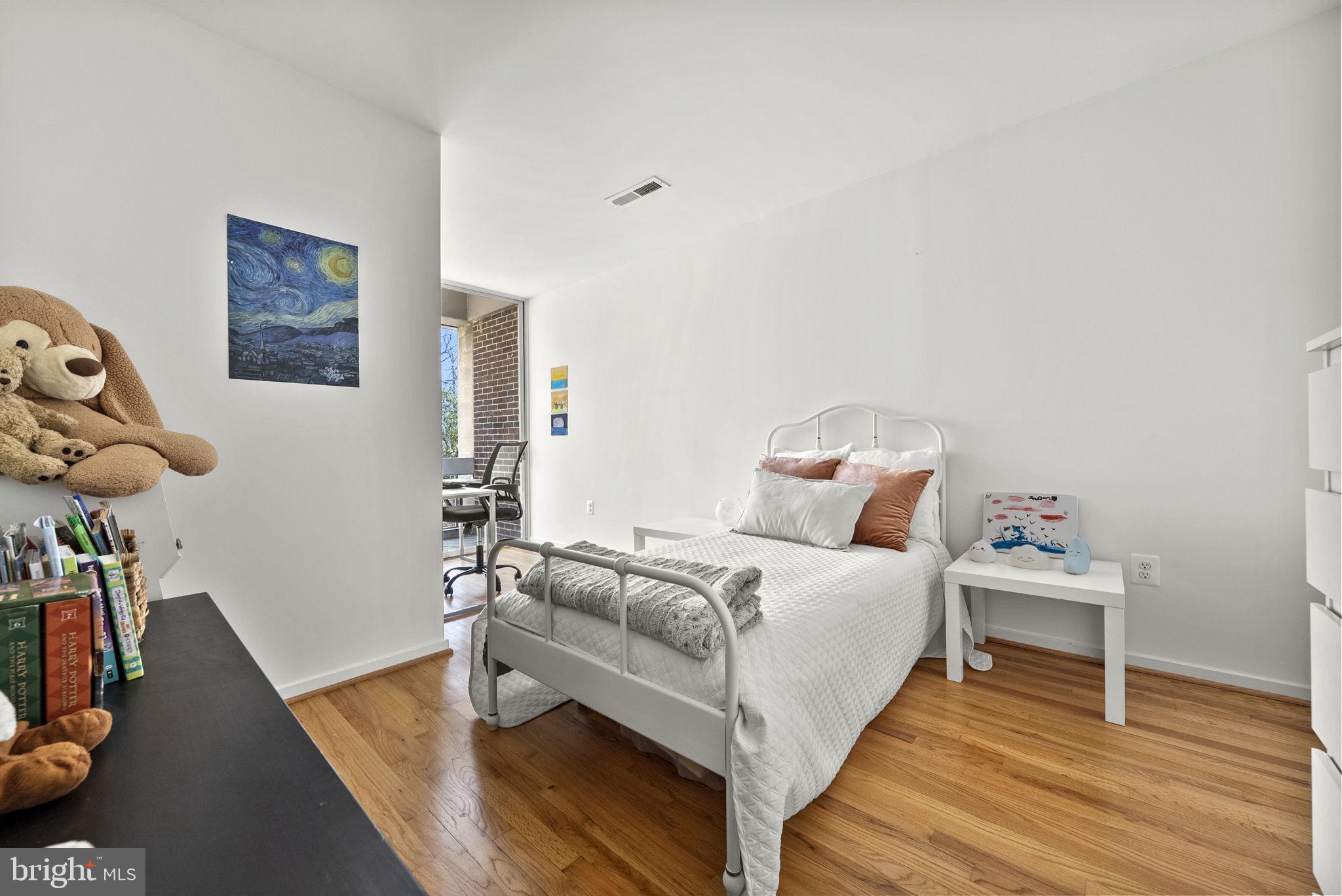 11585 Maple Ridge Road Reston, VA 20190 - Photo 26 of 48 a room with a bed and wooden floor