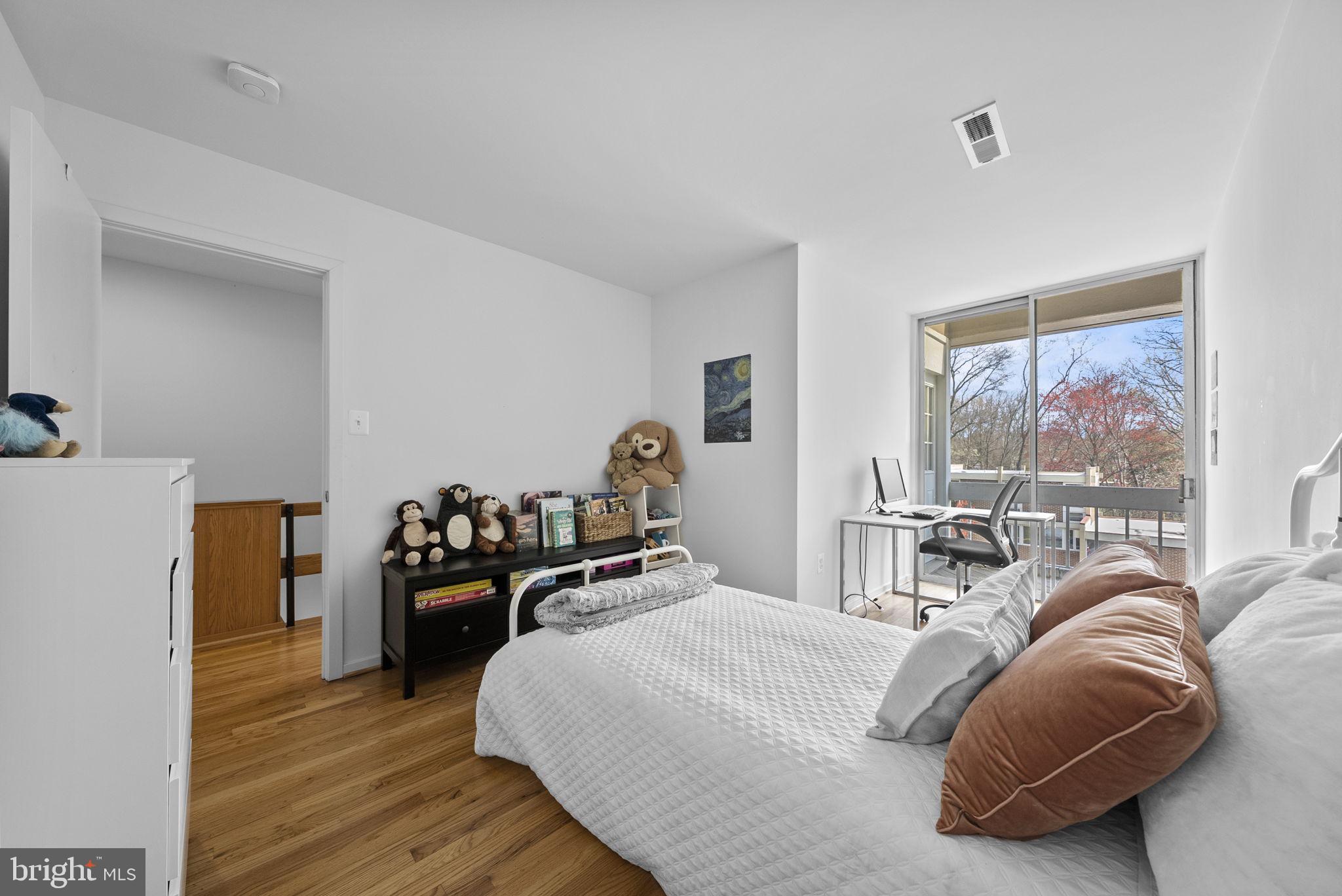 11585 Maple Ridge Road Reston, VA 20190 - Photo 27 of 48 a bed room with a bed and a large window