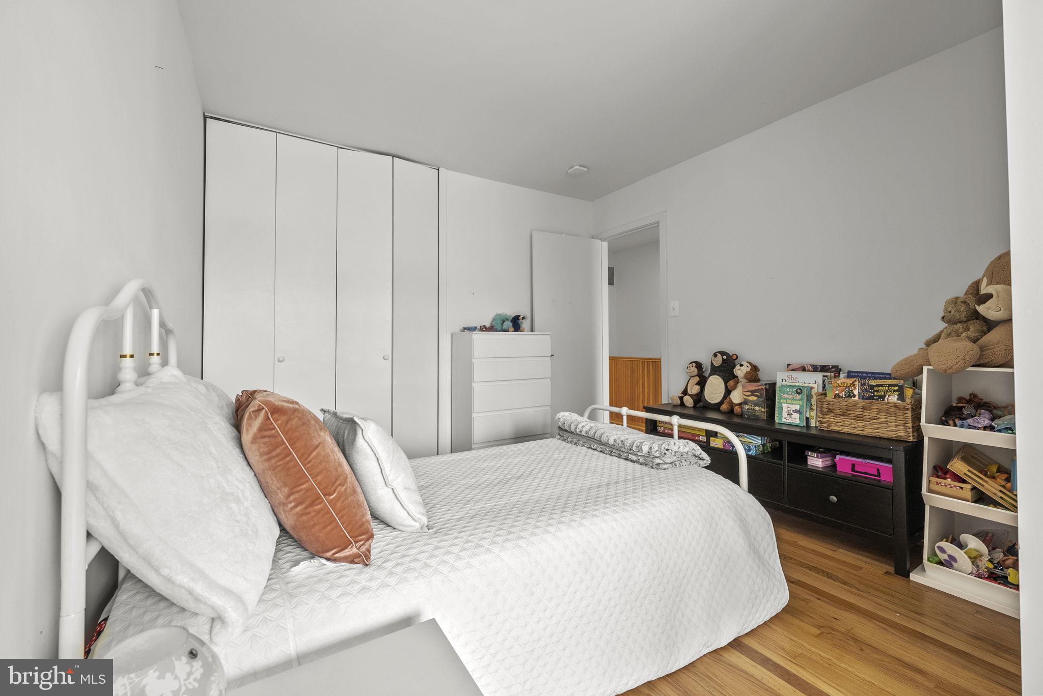 11585 Maple Ridge Road Reston, VA 20190 - Photo 29 of 48 a bedroom with a bed and a wooden floor