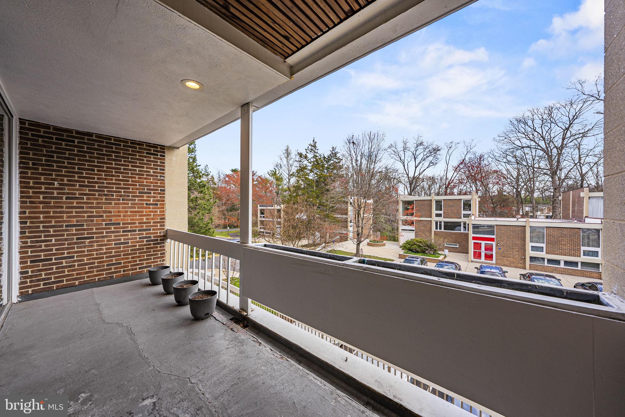 11585 Maple Ridge Road Reston, VA 20190 - Photo 33 of 48 a view of roof deck with furniture and trees around