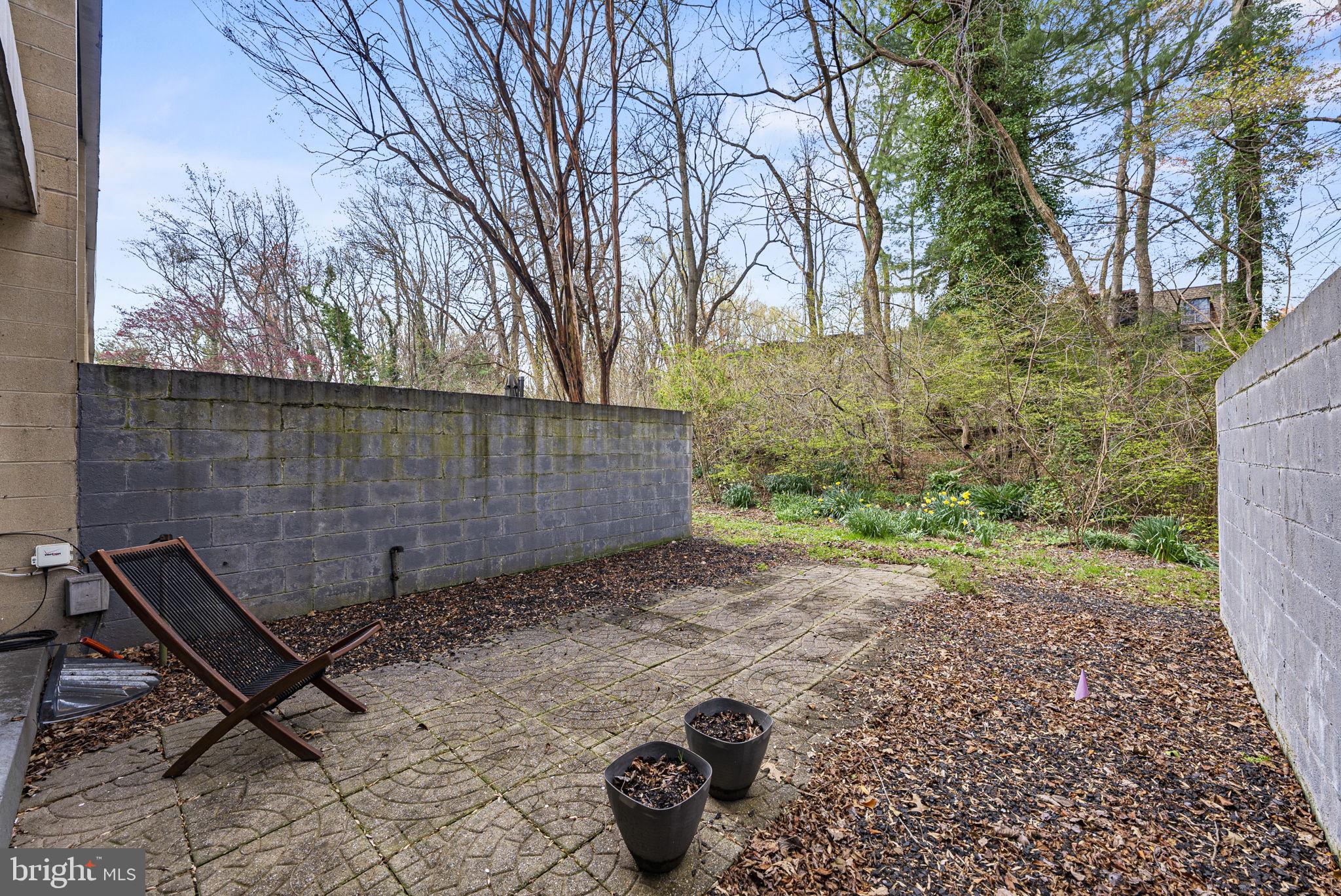 11585 Maple Ridge Road Reston, VA 20190 - Photo 35 of 48 a backyard of a house with table and chairs