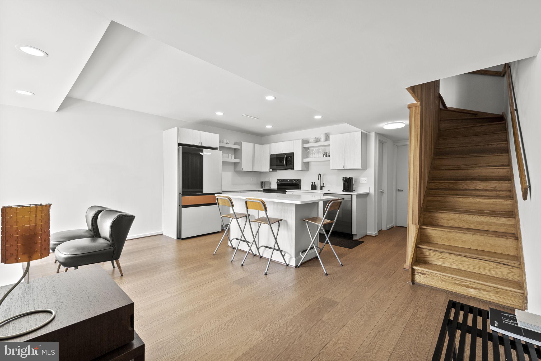 11585 Maple Ridge Road Reston, VA 20190 - Photo 5 of 48 a living room with furniture and a dining table with kitchen view