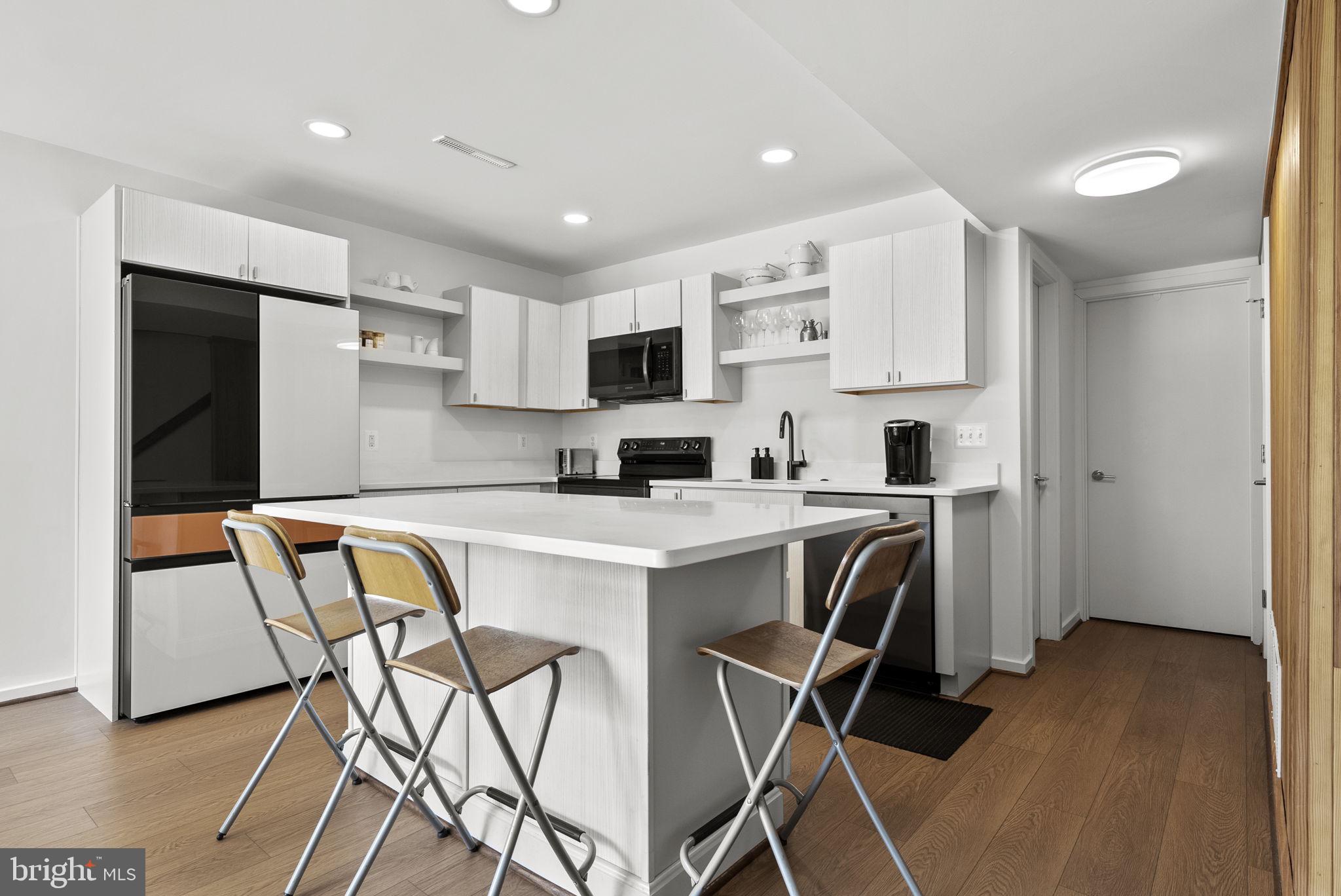 11585 Maple Ridge Road Reston, VA 20190 - Photo 6 of 48 a kitchen that has a cabinets and a dining table chair