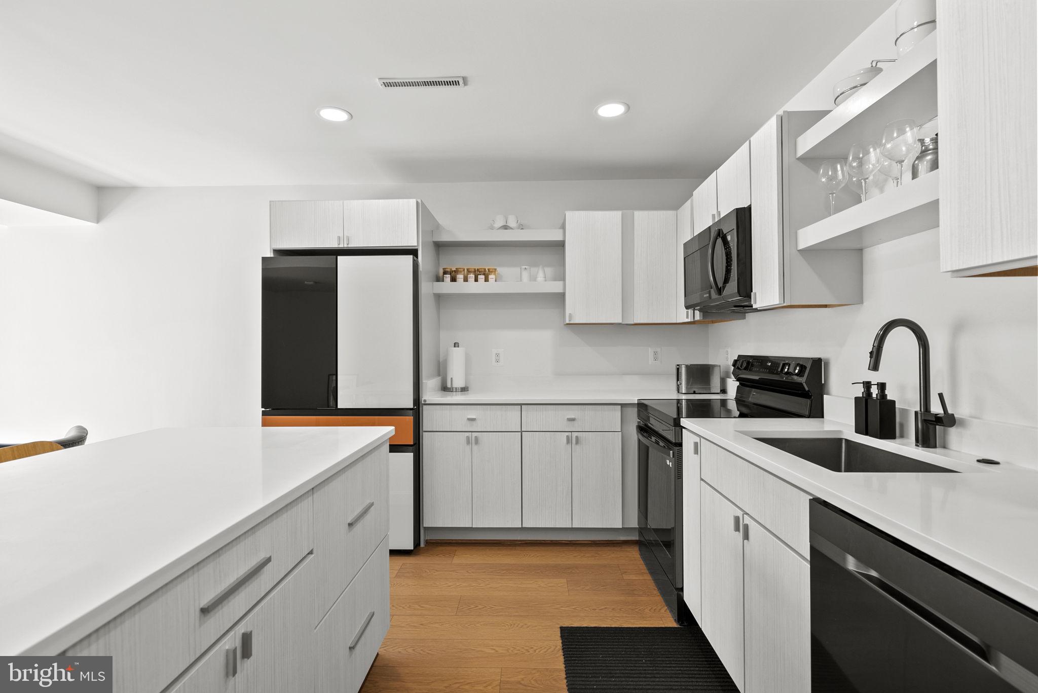 11585 Maple Ridge Road Reston, VA 20190 - Photo 7 of 48 a kitchen with stainless steel appliances granite countertop a sink and cabinets