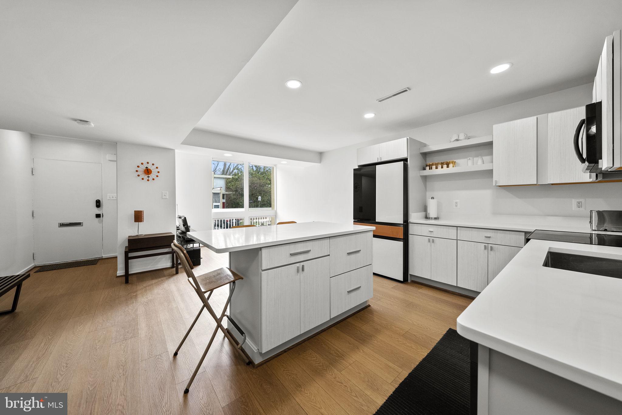 11585 Maple Ridge Road Reston, VA 20190 - Photo 8 of 48 a kitchen with sink cabinets and wooden floor
