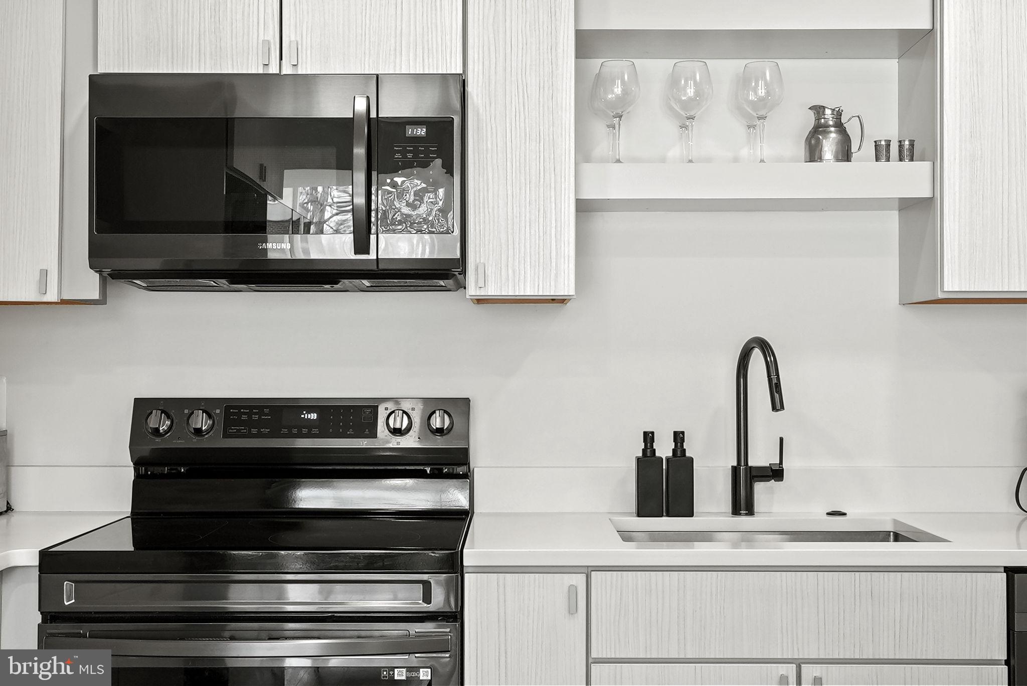 11585 Maple Ridge Road Reston, VA 20190 - Photo 10 of 48 a kitchen with a stove and a microwave