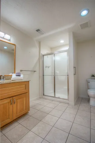 a spacious bathroom with a granite countertop sink a mirror and a vanity