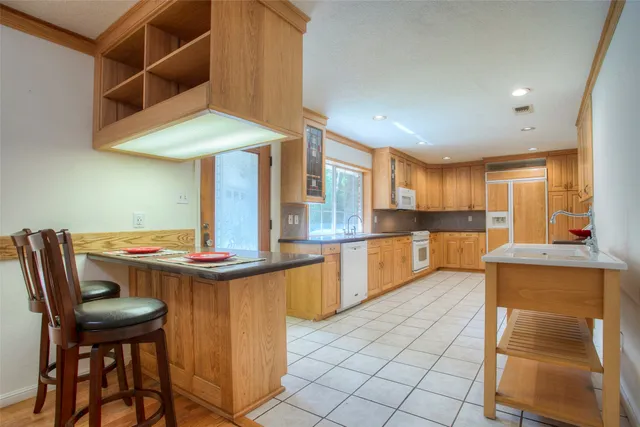 a kitchen with stainless steel appliances a sink and cabinets