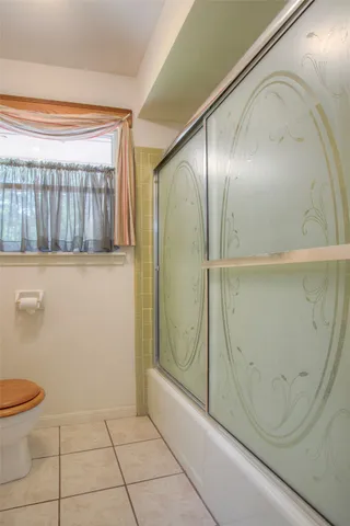 a bathroom with a glass shower door