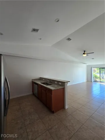 a kitchen with granite countertop a sink and a stove