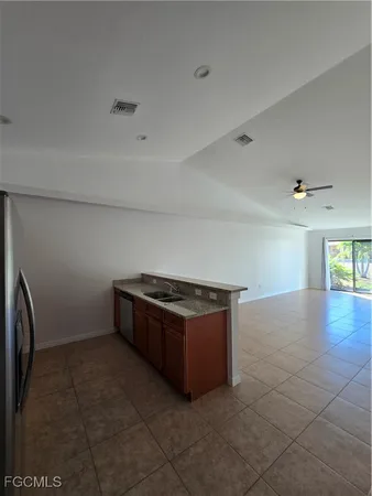 a kitchen with granite countertop a sink and a stove