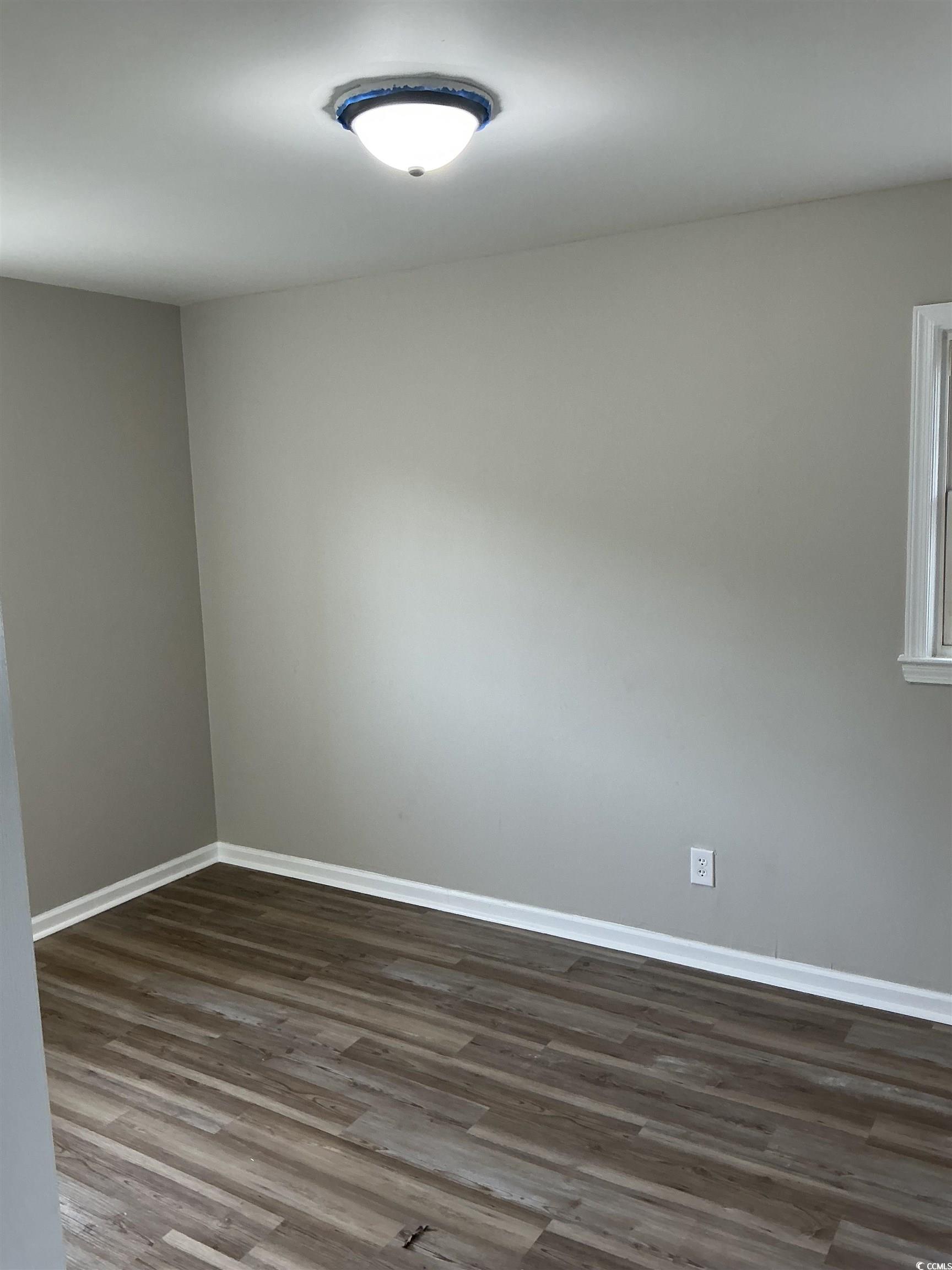 105 Mace Court Latta, SC 29565 - Photo 11 of 12 Empty room with dark wood-style floors and baseboards