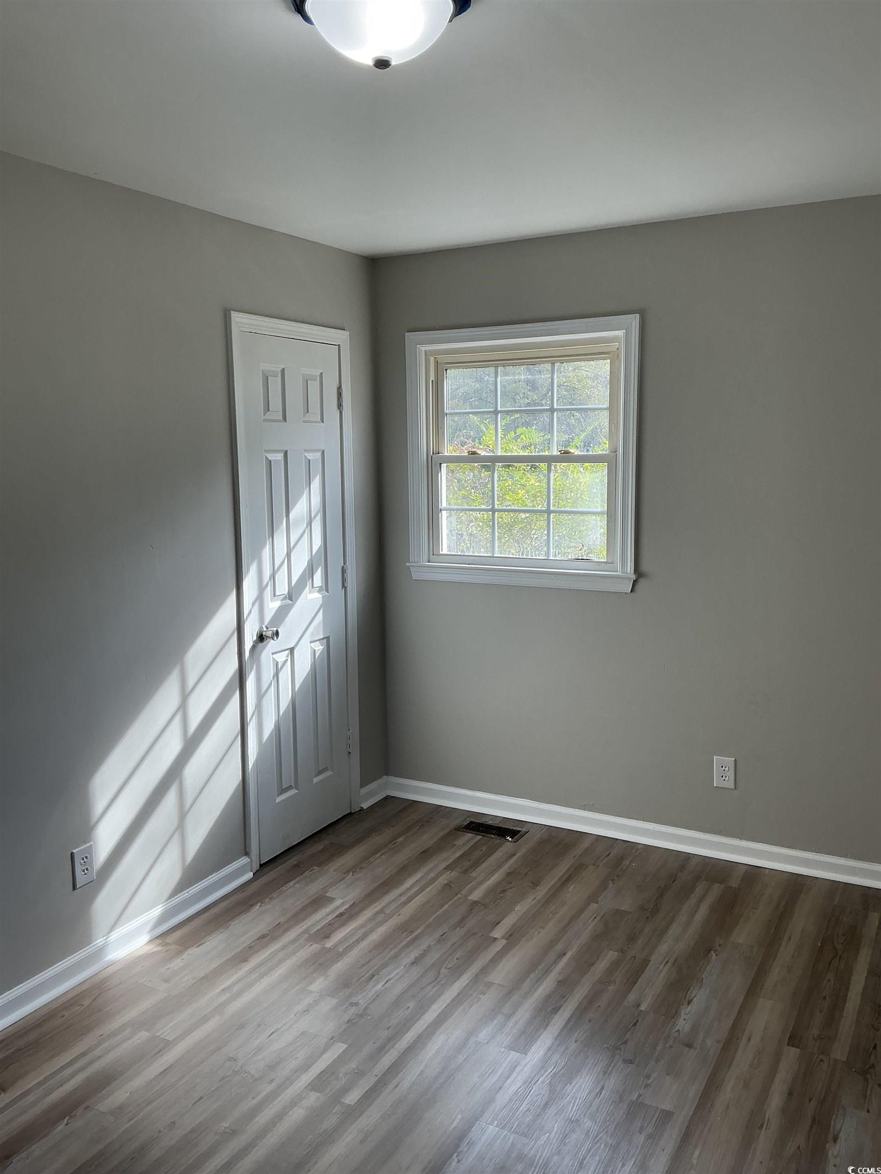 105 Mace Court Latta, SC 29565 - Photo 9 of 12 Unfurnished room featuring wood finished floors and baseboards