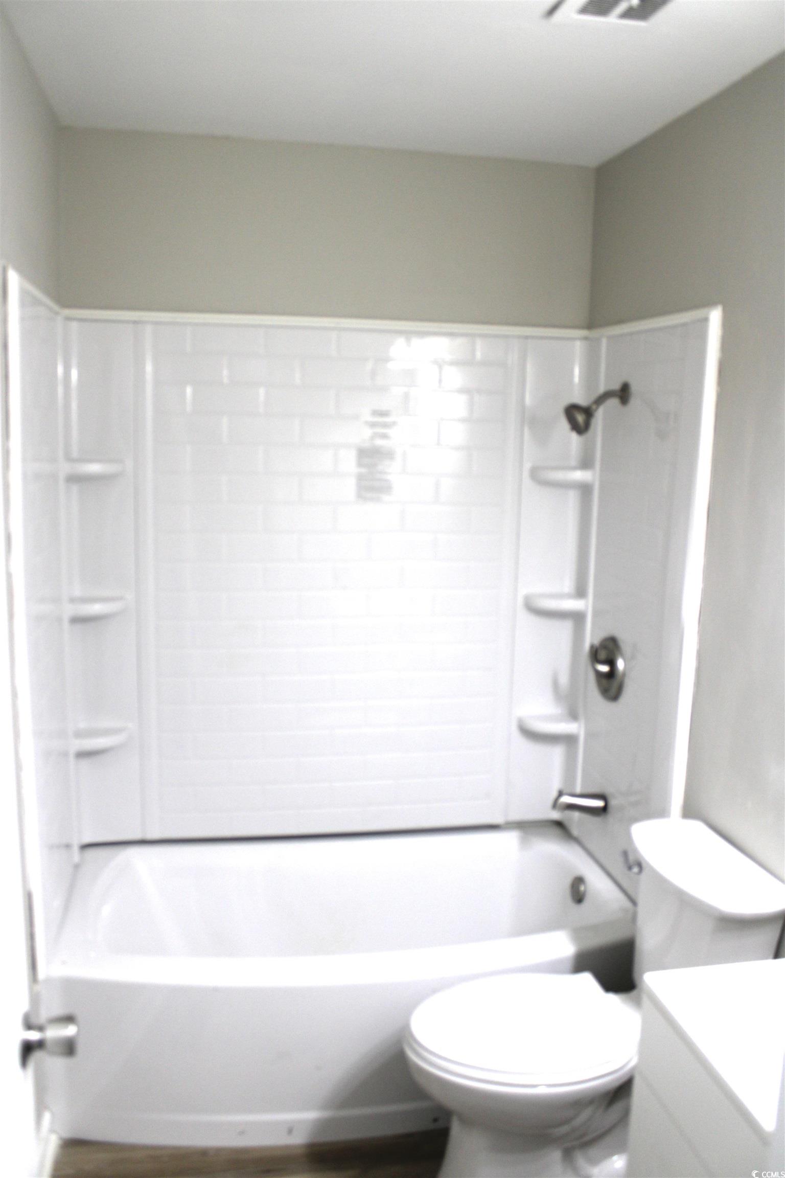 105 Mace Court Latta, SC 29565 - Photo 10 of 12 Full bath with vanity, washtub / shower combination, and wood finished floors
