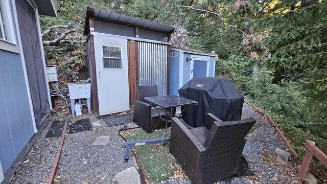 a view of a house with backyard and sitting area