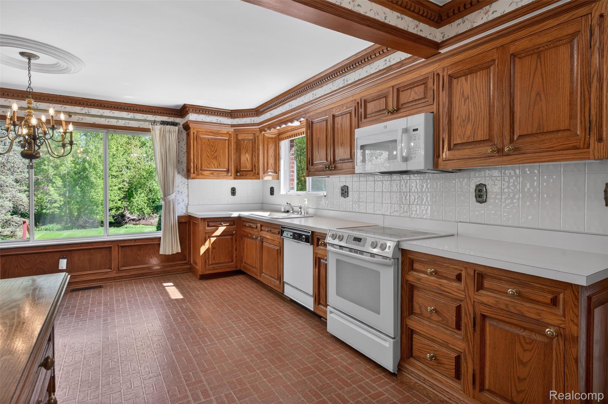 15623 Millar Road Clinton Township, MI 48036 - Photo 40 of 56 Kitchen featuring brick patterned flooring, white appliances, light countertops, suspended lighting, and wood finish cabinets