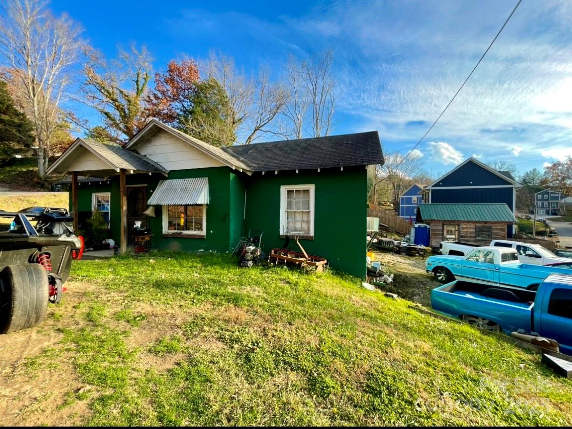 a view of a house with backyard porch and sitting area