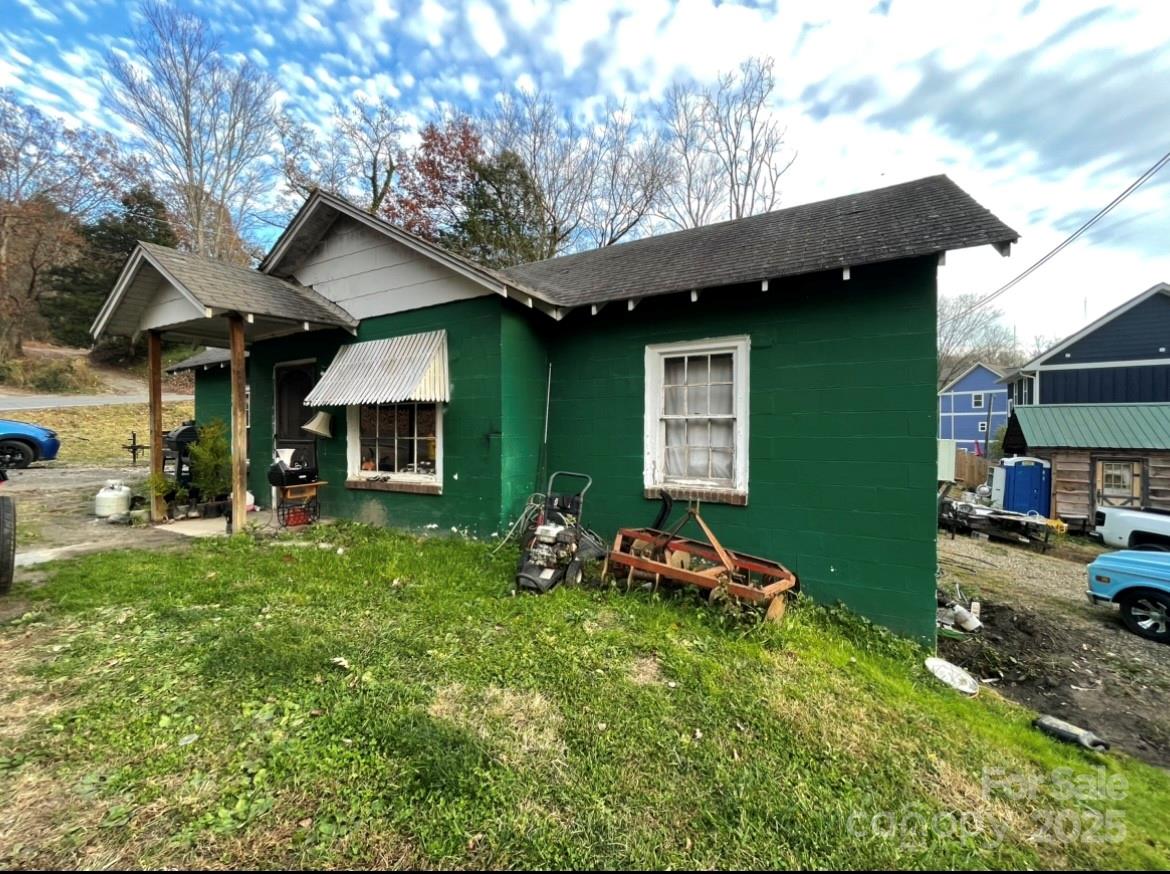 130 Lookout Road Asheville, NC 28804 - Photo 11 of 18 a front view of a house with a yard table and chairs