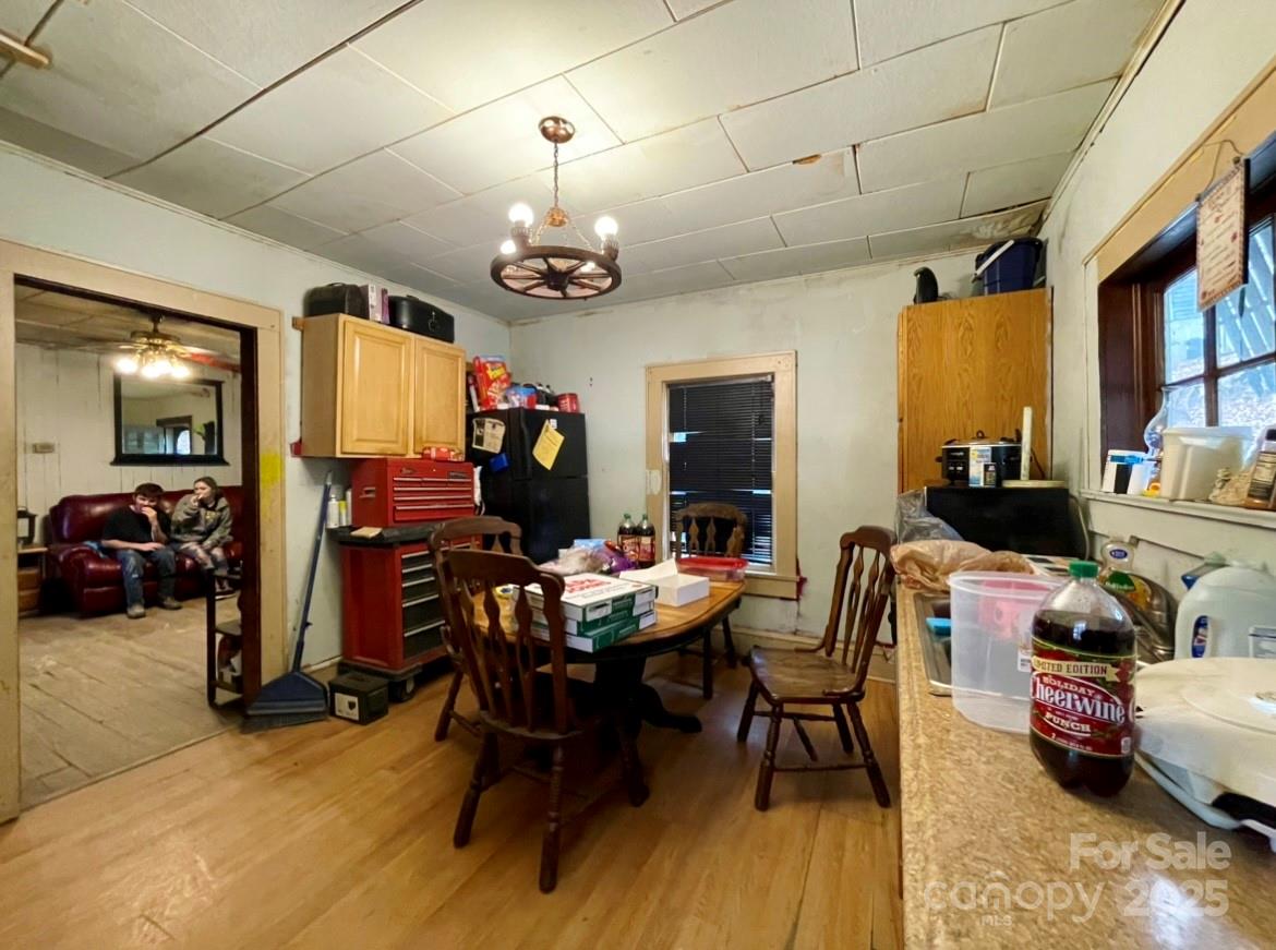 130 Lookout Road Asheville, NC 28804 - Photo 15 of 18 a view of a dining room with furniture a chandelier and wooden floor