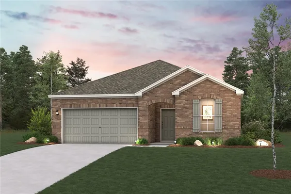 a front view of a house with a garden and yard