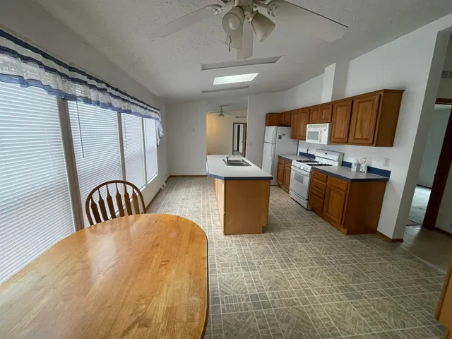 a kitchen with refrigerator cabinets and a sink