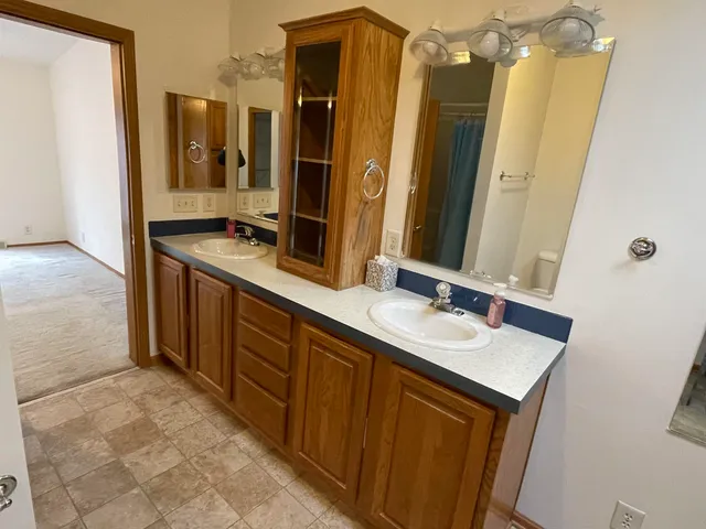 a bathroom with a double vanity sink a and a mirror