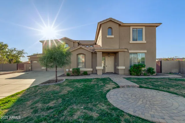 a front view of a house with a garden and plants