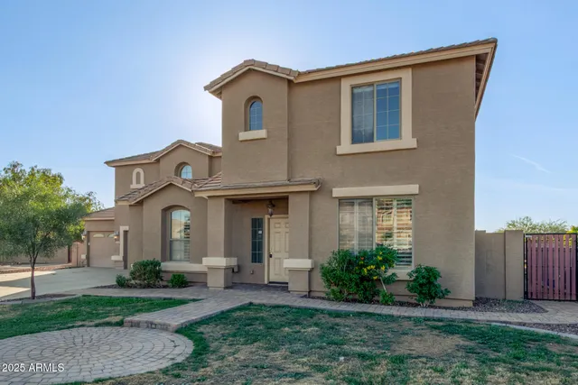 a front view of a house with a yard and porch