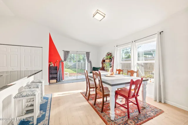 a kitchen with stainless steel appliances kitchen island granite countertop a refrigerator a stove a sink dishwasher and a dining table with the kitchen view