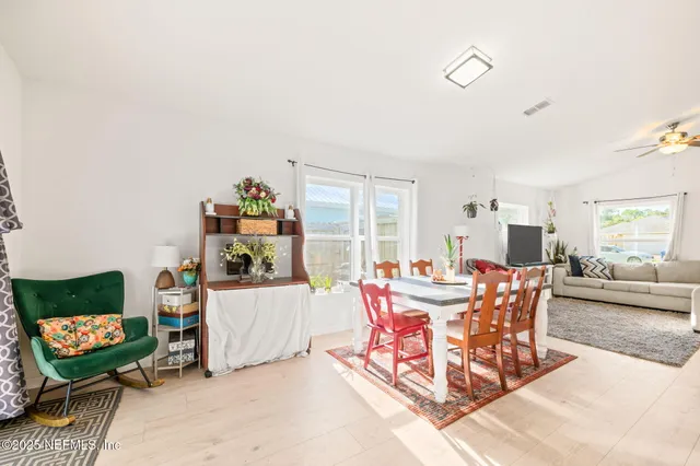 a view of a kitchen with kitchen island stainless steel appliances a sink stove and refrigerator