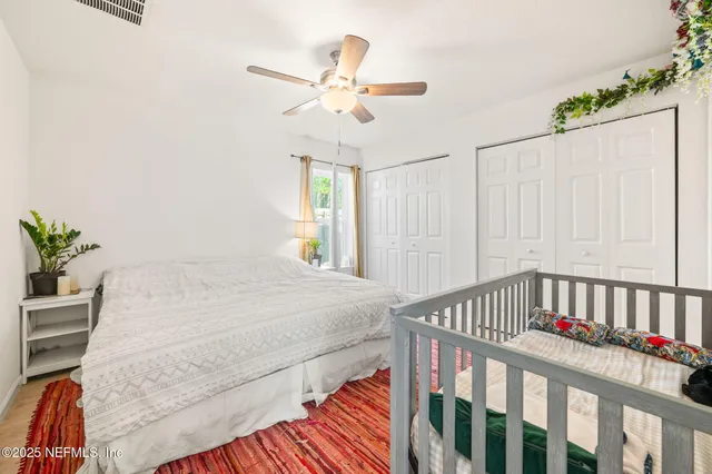 a bedroom with furniture and a large window