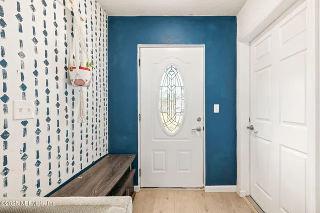 a living room with furniture a rug and a flat screen tv