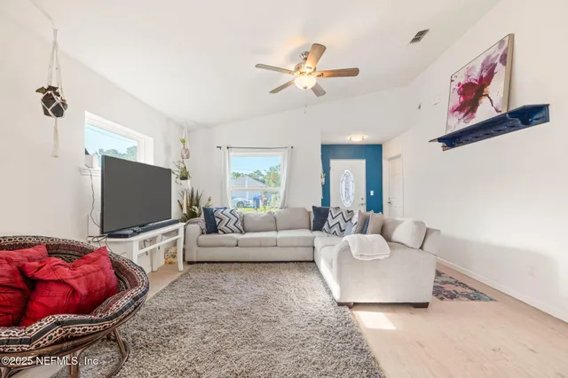 a living room with furniture and a flat screen tv