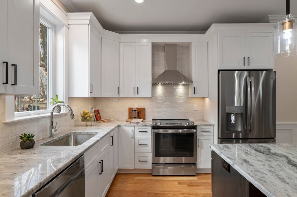 297 Riverside Drive Northampton, MA 01062 - Photo 11 of 32 a kitchen with stainless steel appliances granite countertop a sink stove and refrigerator