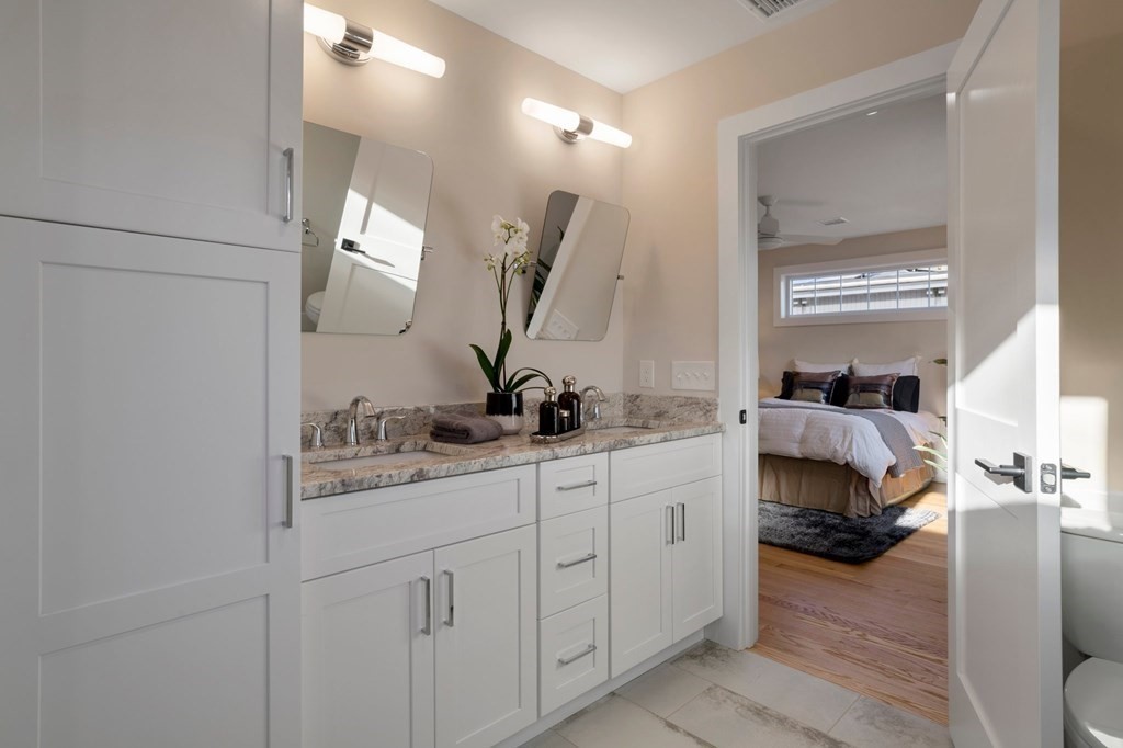 297 Riverside Drive Northampton, MA 01062 - Photo 23 of 32 a en suite bathroom with a double vanity sink and a mirror
