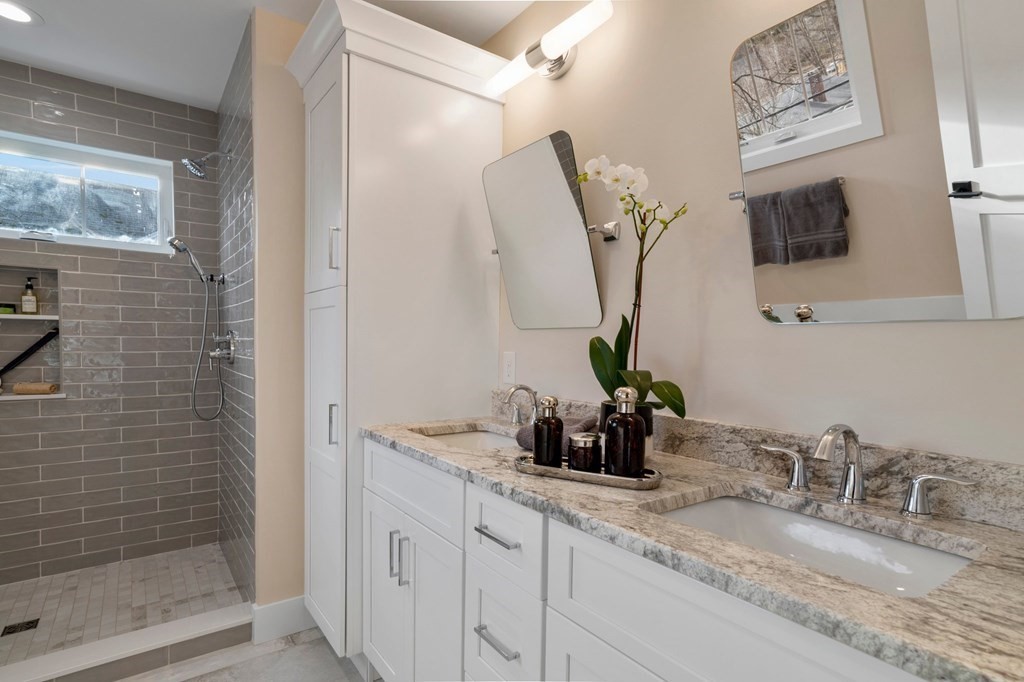 297 Riverside Drive Northampton, MA 01062 - Photo 24 of 32 a bathroom with a double vanity sink and a mirror