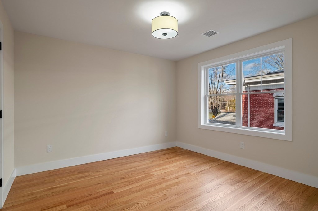 297 Riverside Drive Northampton, MA 01062 - Photo 28 of 32 an empty room with wooden floor and windows