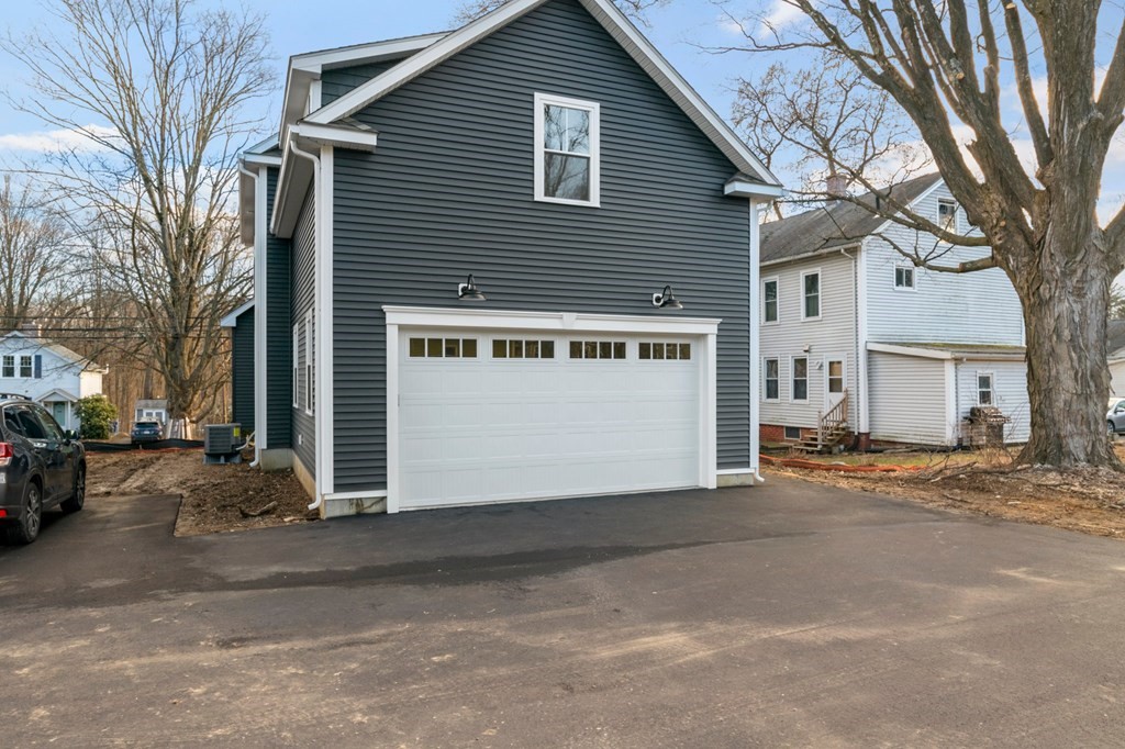 297 Riverside Drive Northampton, MA 01062 - Photo 32 of 32 a view of a house with a yard and garage