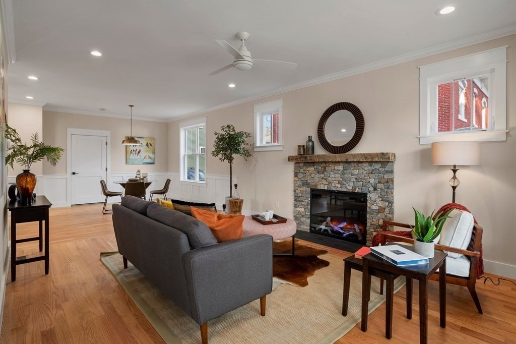 297 Riverside Drive Northampton, MA 01062 - Photo 5 of 32 a living room with furniture a clock and a fireplace